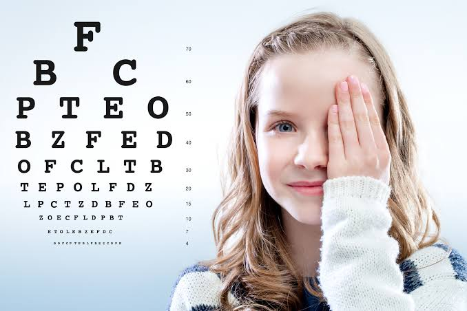 Child taking an eye chart vision test
